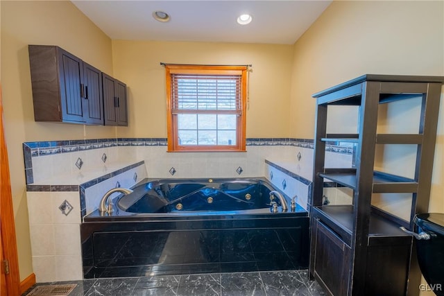 bathroom featuring recessed lighting and a whirlpool tub