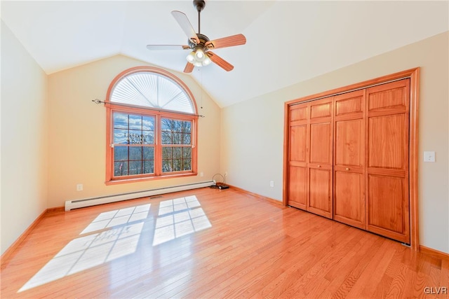 unfurnished bedroom featuring lofted ceiling, baseboards, light wood finished floors, and baseboard heating