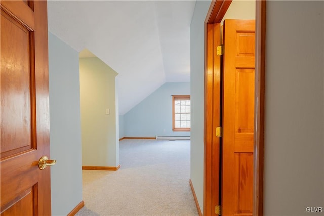 hall with carpet floors, a baseboard radiator, baseboards, and lofted ceiling