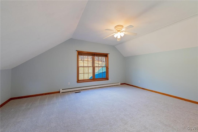 additional living space featuring baseboards, a ceiling fan, lofted ceiling, a baseboard radiator, and carpet floors