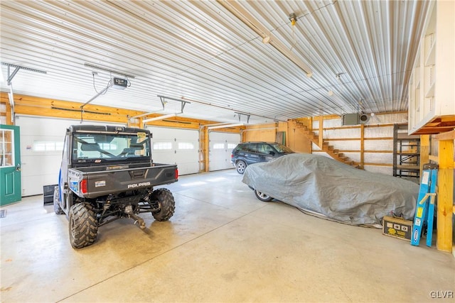 garage with a garage door opener and metal wall