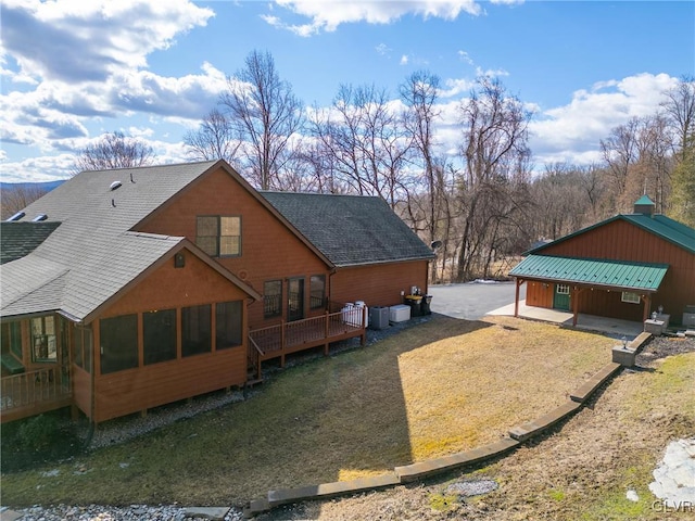 exterior space featuring metal roof, a shingled roof, and central air condition unit