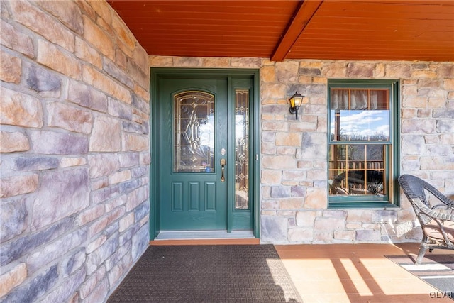 property entrance with stone siding