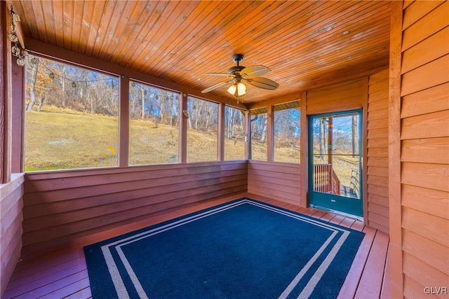 unfurnished sunroom with wood ceiling and ceiling fan