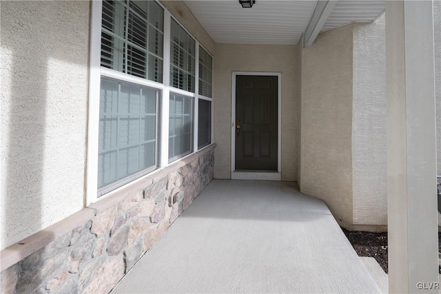 doorway to property with stucco siding