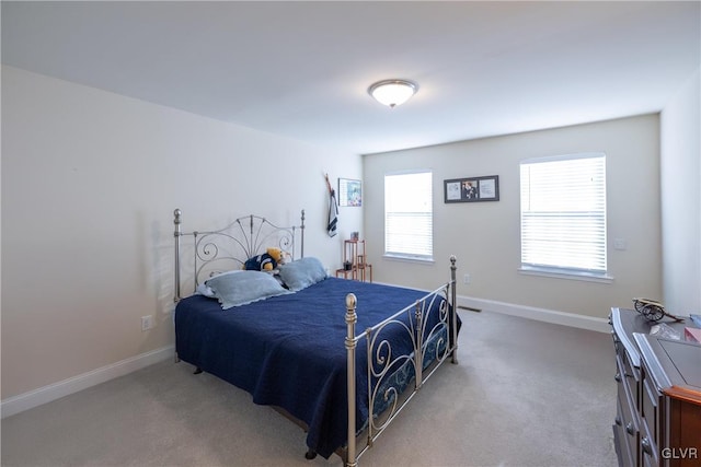 bedroom featuring carpet and baseboards