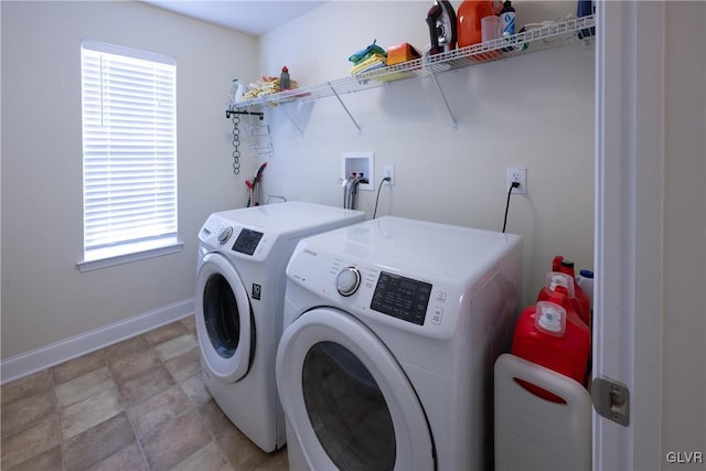 clothes washing area with laundry area, washer and clothes dryer, and baseboards