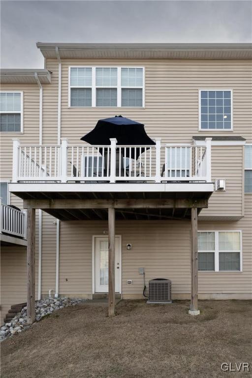 back of house with a deck and cooling unit