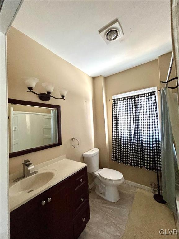 full bathroom with toilet, vanity, and a shower with curtain