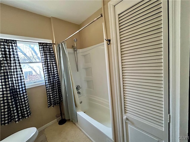 bathroom featuring shower / bath combo with shower curtain, toilet, and baseboards