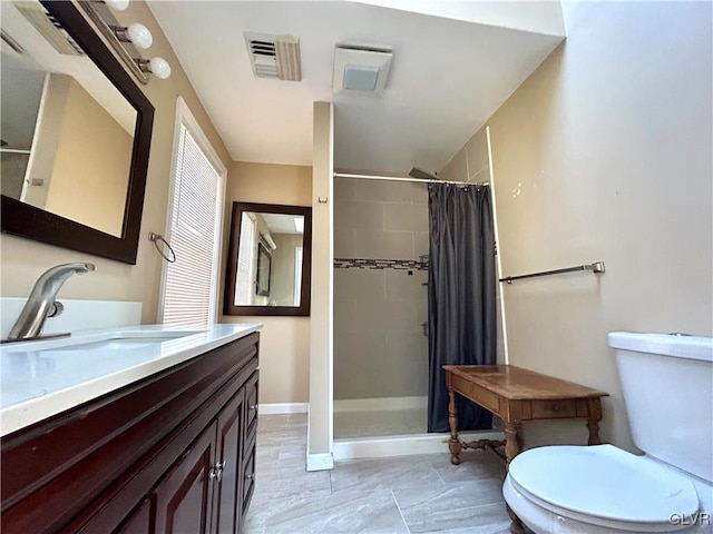 bathroom featuring visible vents, toilet, a tile shower, vanity, and baseboards