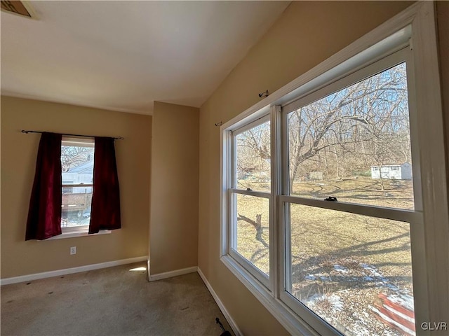 carpeted empty room with visible vents and baseboards