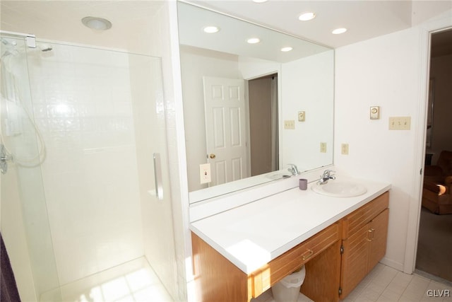 bathroom with a stall shower, recessed lighting, tile patterned flooring, and vanity