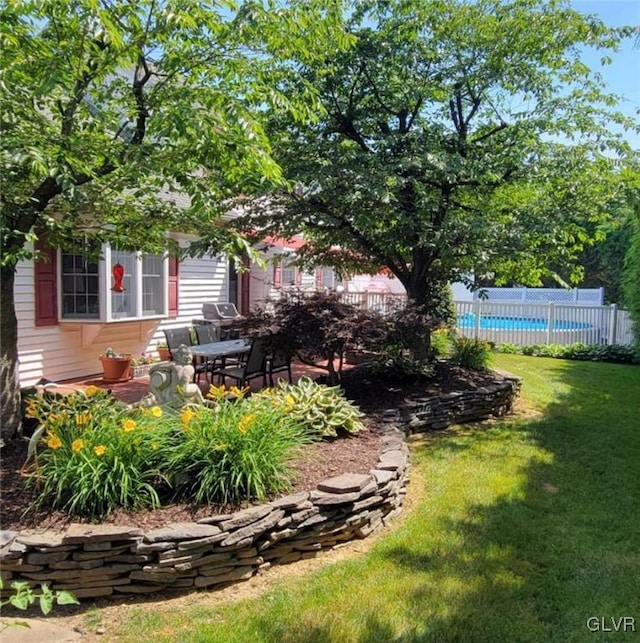 view of yard featuring a patio, fence, and a fenced in pool