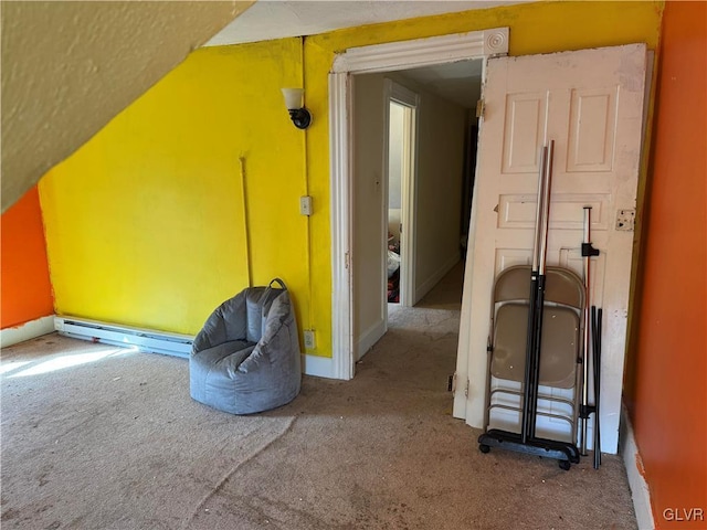 additional living space with baseboard heating, carpet, and baseboards