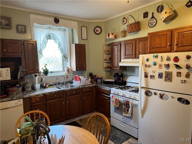 kitchen featuring white appliances, under cabinet range hood, ornamental molding, and a sink