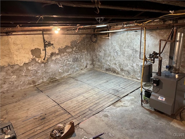 unfinished basement featuring a heating unit