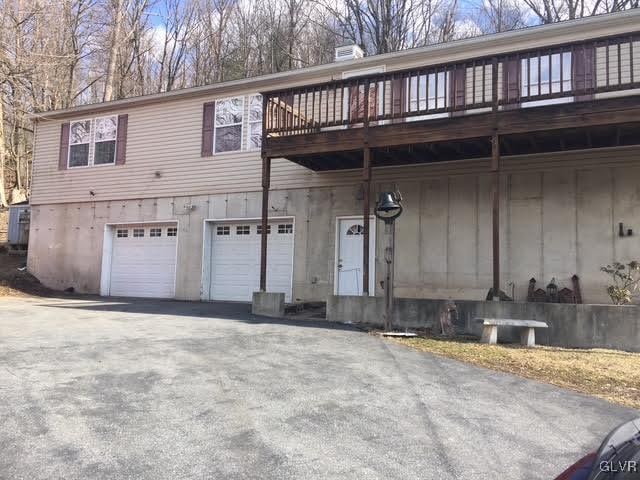 view of front of house with aphalt driveway and an attached garage