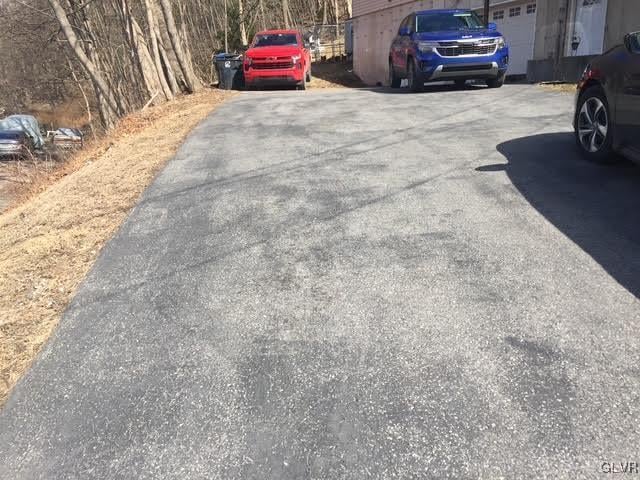 view of parking / parking lot with driveway