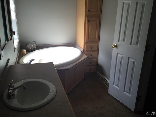 bathroom with a bathtub and a sink