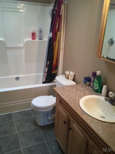 bathroom with shower / bath combo, vanity, toilet, and tile patterned floors