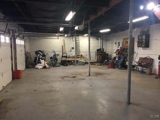 garage with electric panel and a garage door opener