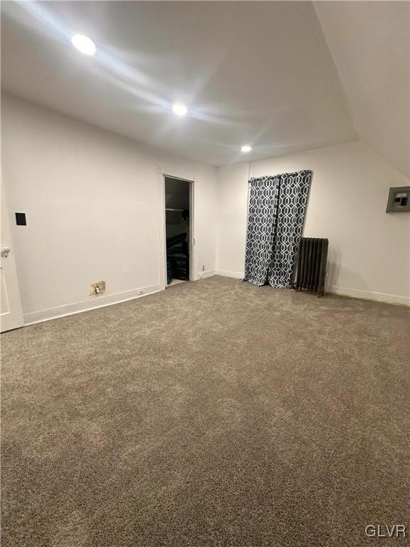 interior space with recessed lighting, carpet, lofted ceiling, and baseboards