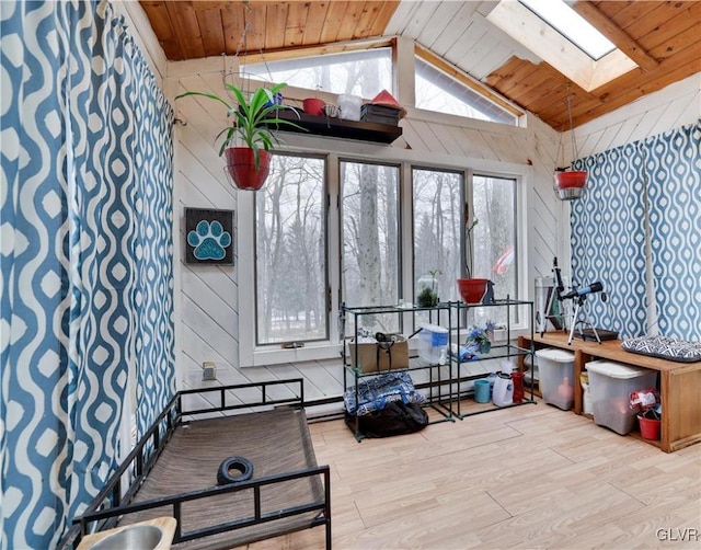 sunroom with wooden ceiling and vaulted ceiling with skylight