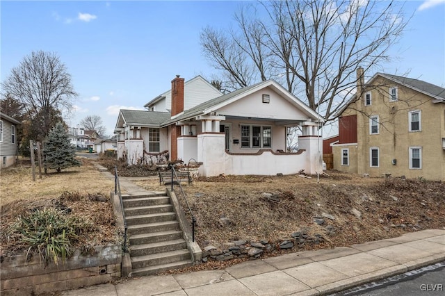 bungalow-style house with a chimney