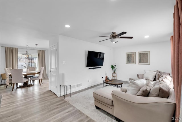 living area with recessed lighting, visible vents, baseboards, a ceiling fan, and light wood-style floors