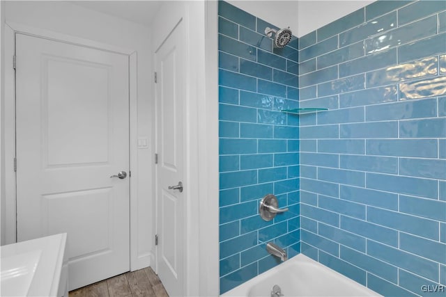 full bath featuring shower / bath combination and wood finished floors