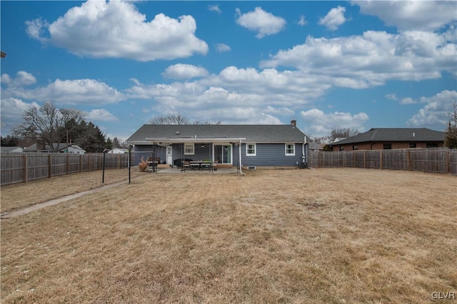 rear view of house featuring a lawn, a patio area, and a fenced backyard