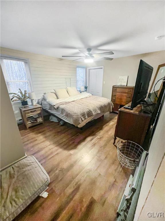 bedroom featuring a ceiling fan and wood finished floors