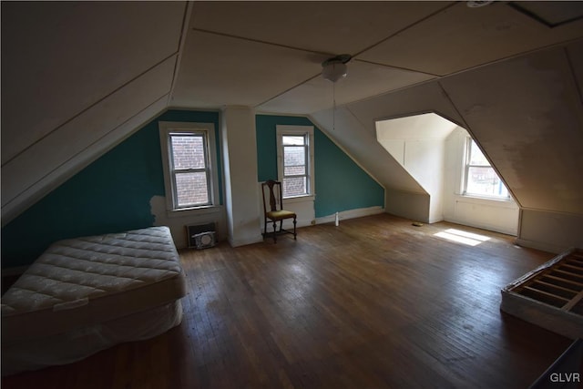 additional living space with lofted ceiling and hardwood / wood-style floors