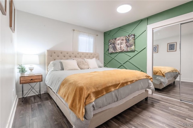 bedroom featuring a closet, baseboards, and wood finished floors