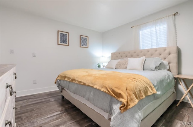 bedroom with dark wood-style flooring and baseboards