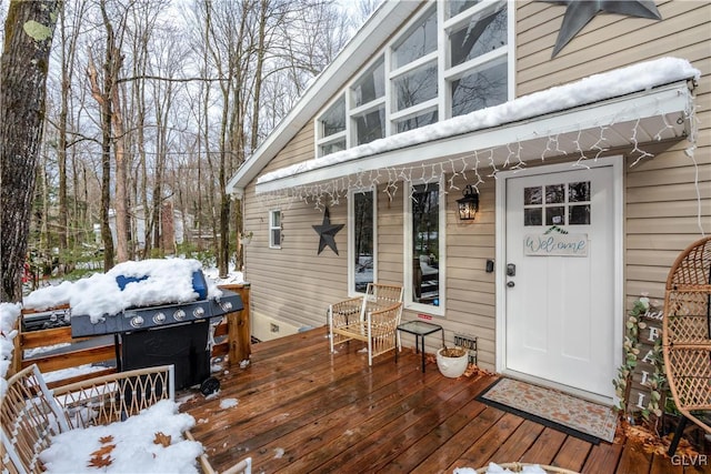 snow covered deck featuring area for grilling