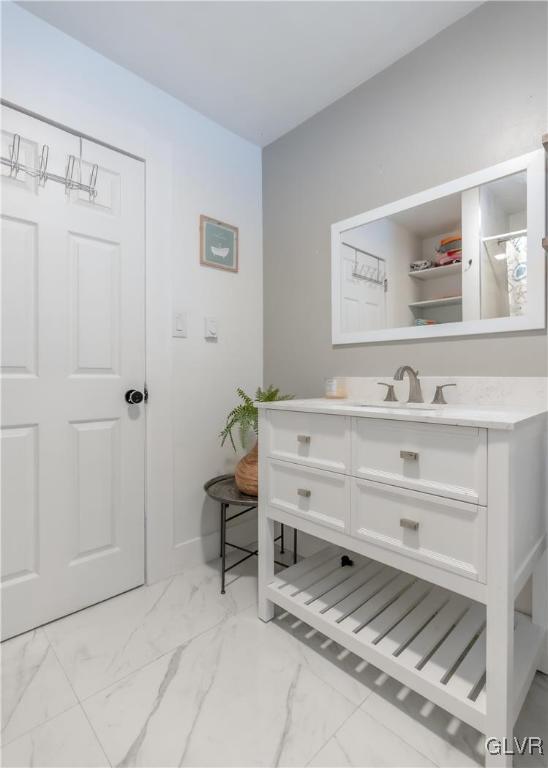 interior space featuring marble finish floor and vanity