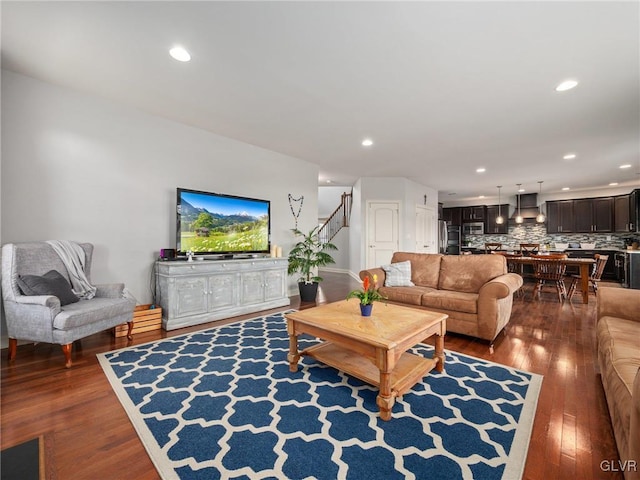 living area featuring stairway, wood finished floors, and recessed lighting