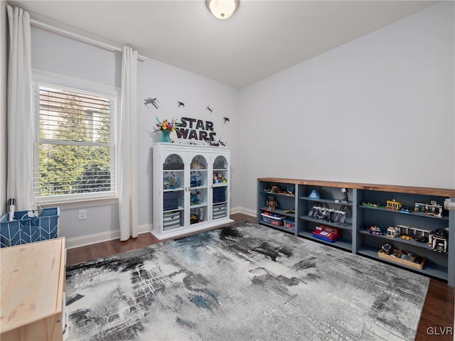 interior space with baseboards and wood finished floors