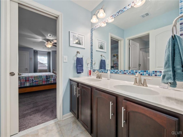 bathroom with ensuite bath, visible vents, and a sink