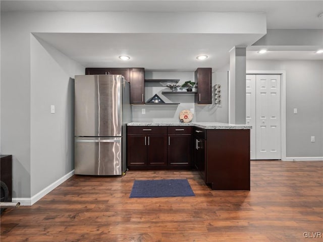 kitchen with baseboards, dark wood-style flooring, freestanding refrigerator, dark brown cabinets, and open shelves