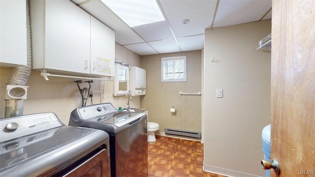 laundry area with a baseboard heating unit, washer and dryer, and laundry area