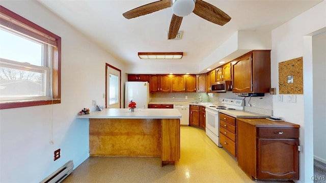 kitchen featuring a baseboard radiator, light countertops, visible vents, white appliances, and a peninsula