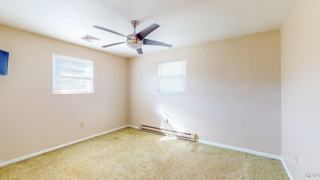 spare room featuring plenty of natural light, a baseboard radiator, visible vents, and a ceiling fan