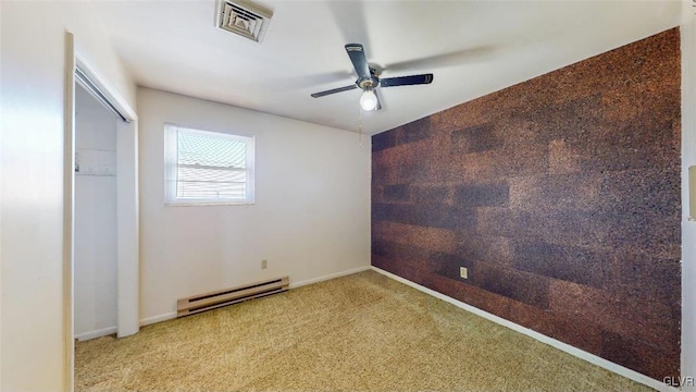 carpeted spare room with a baseboard radiator, visible vents, ceiling fan, and baseboards