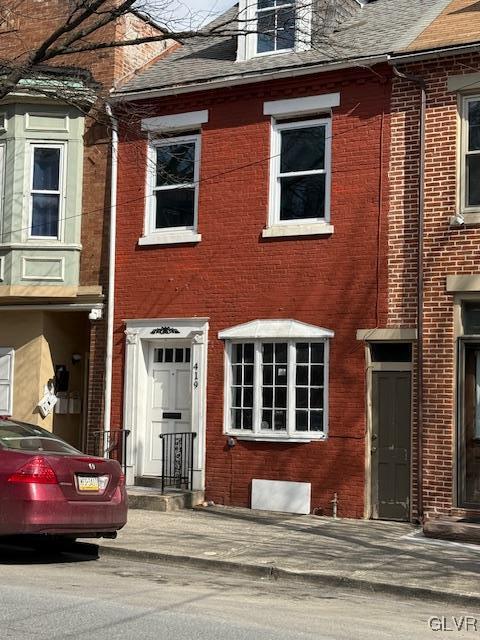 view of property with brick siding