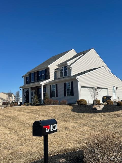 view of front of property with an attached garage and a front yard