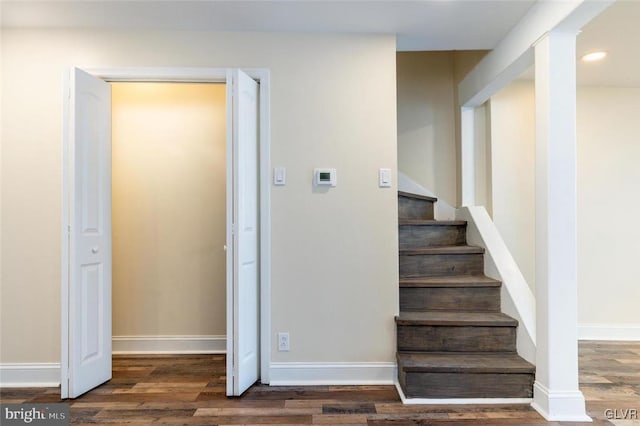 staircase featuring recessed lighting, baseboards, and wood finished floors