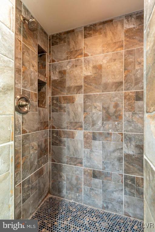 bathroom with tiled shower